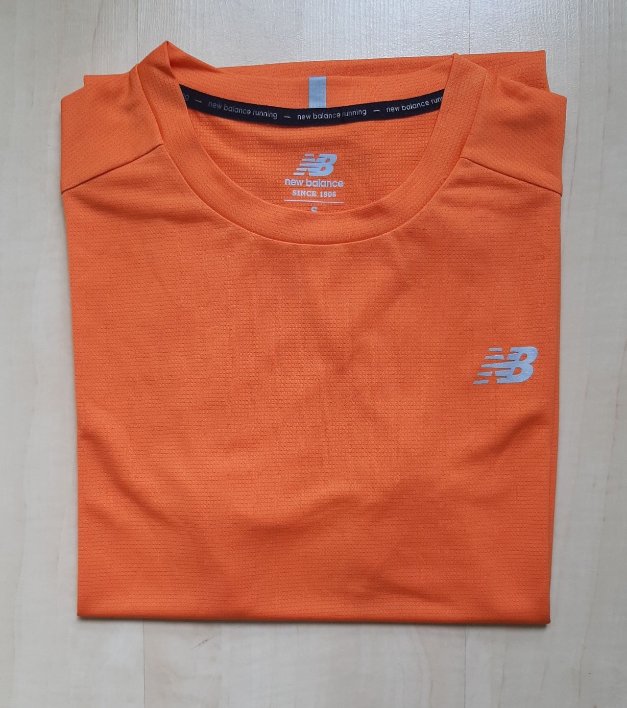 Pomarańczowa, szybkoschnąca koszulka NEW BALANCE, roz. S