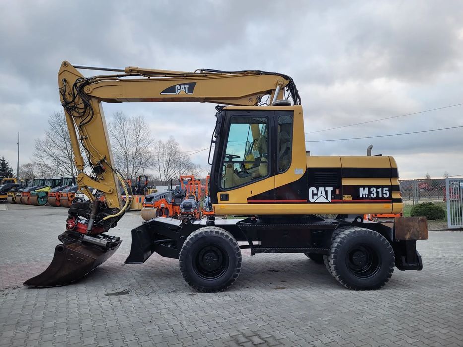 Caterpillar M 315  Koparka Kołowa, Pług, Podpory, Rototilt Rotator INDEXATOR