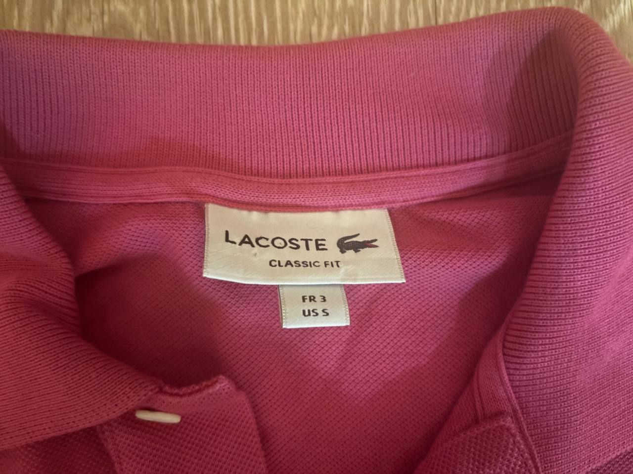поло Lacoste розовое