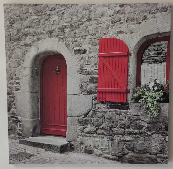 Quadro com a casa de pedra com portas vermelhas