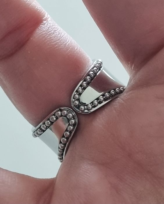 Anel prateado, em aço  com pedra preta oval. Ajustável