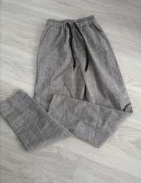 Spodnie materiałowe w kratkę z gumką w pasie
