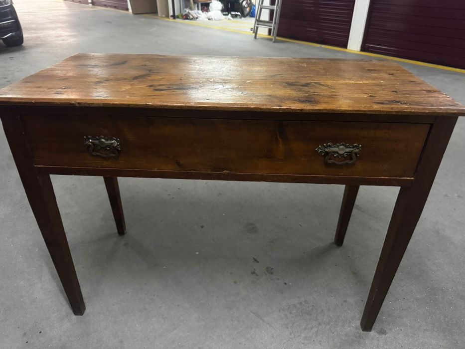 Antique wooden occasional table with a single drawer and tapered legs.
