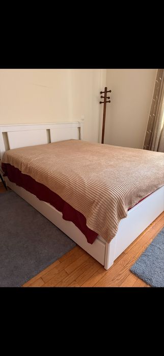 Cama branca de casal com arrumação