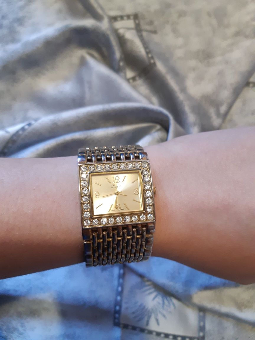 Złoty, damski zegarek z cyrkoniami. Regal, metalowy