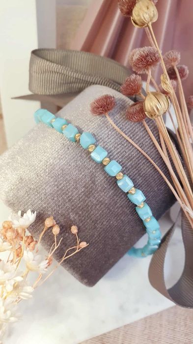 Bransoletka na sznureczku z niebieskimi koralikami.i I złotymi kulkami