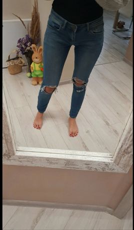 Spodnie jeansowe z dziurami przetarciami M-L