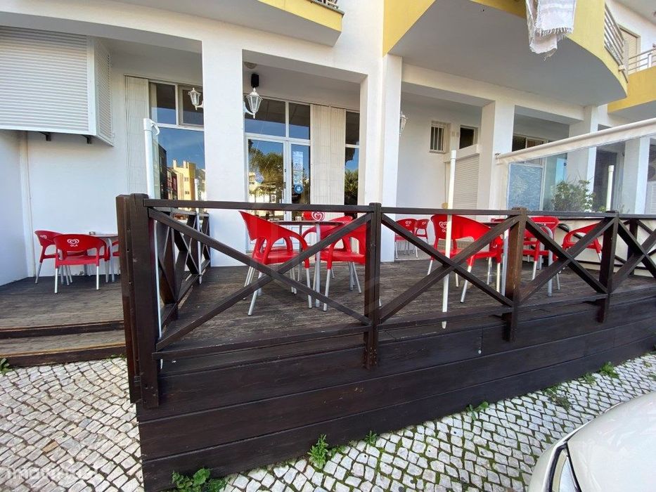 Café com duas esplanadas, na avenida principal de São Brás de Alpor...
