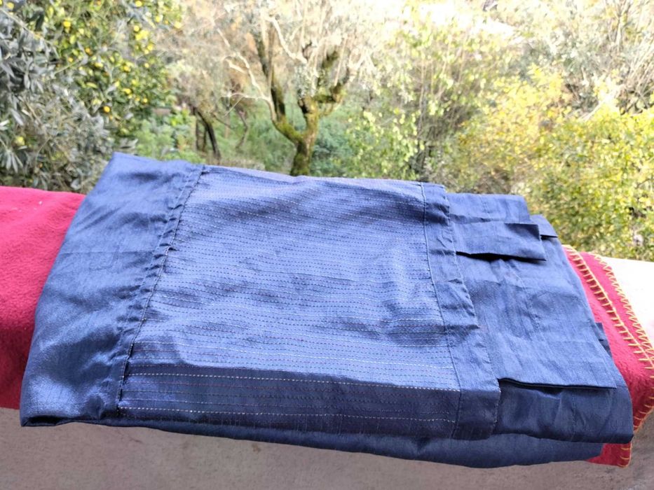 Cortinado azul com tom acetinado com missangas.