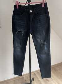 Elastyczne ciemnogranatowe jeansy rurki z dziurami r.W32 L32