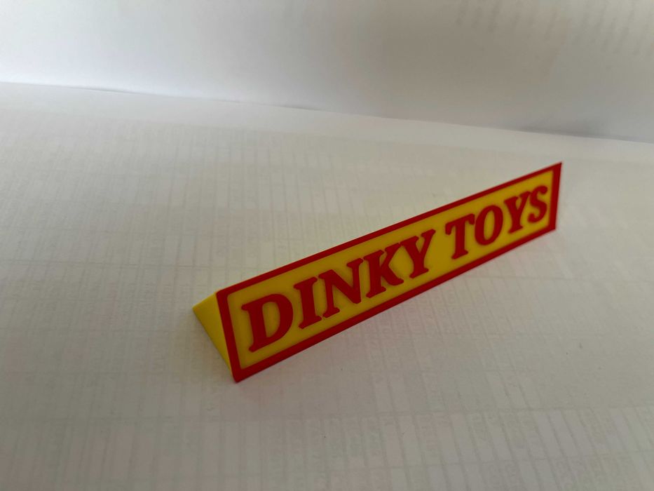 Sinal DINKY TOYS p/expositor miniaturas, paral. triang.reg., amarelo