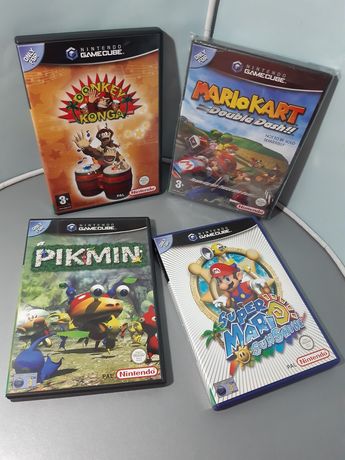 Quatro jogos para GameCube: Donkey Konga, Mario Kart, Pikmin, Sunshine