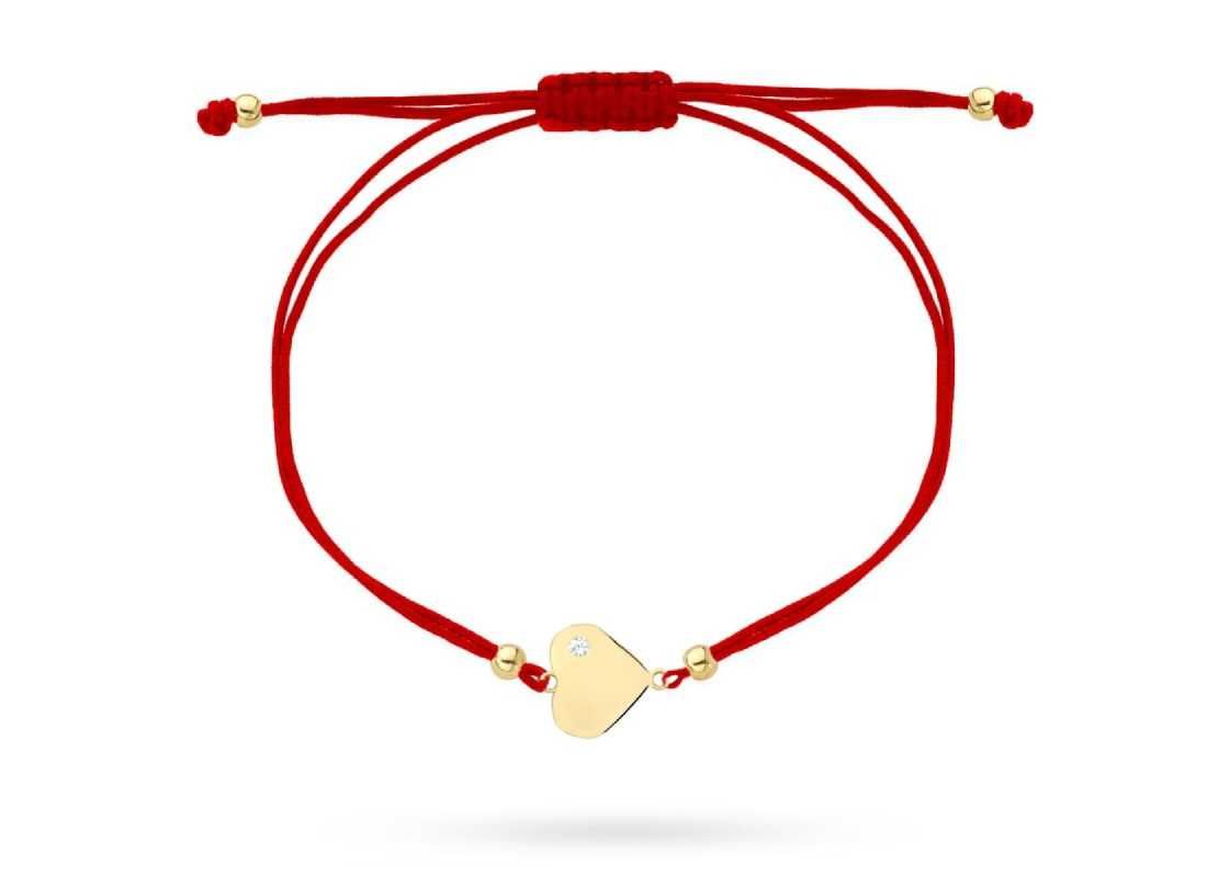 Złota bransoletka 585 serce w poprzek z cyrkonią na czerwonym sznurku