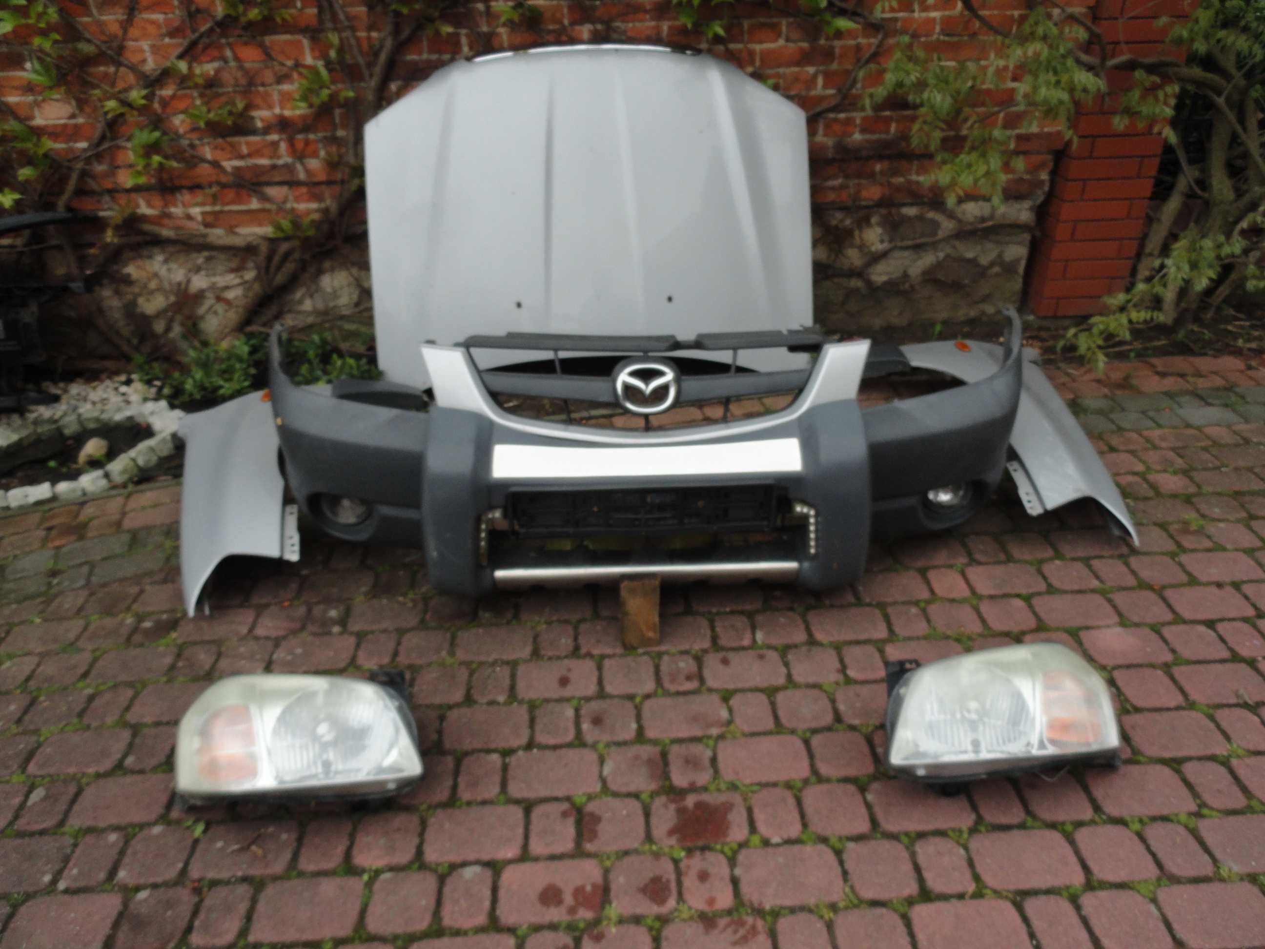 Mazda Tribute Zderzak przód  kpl z nakładką  i halogenami 00-04