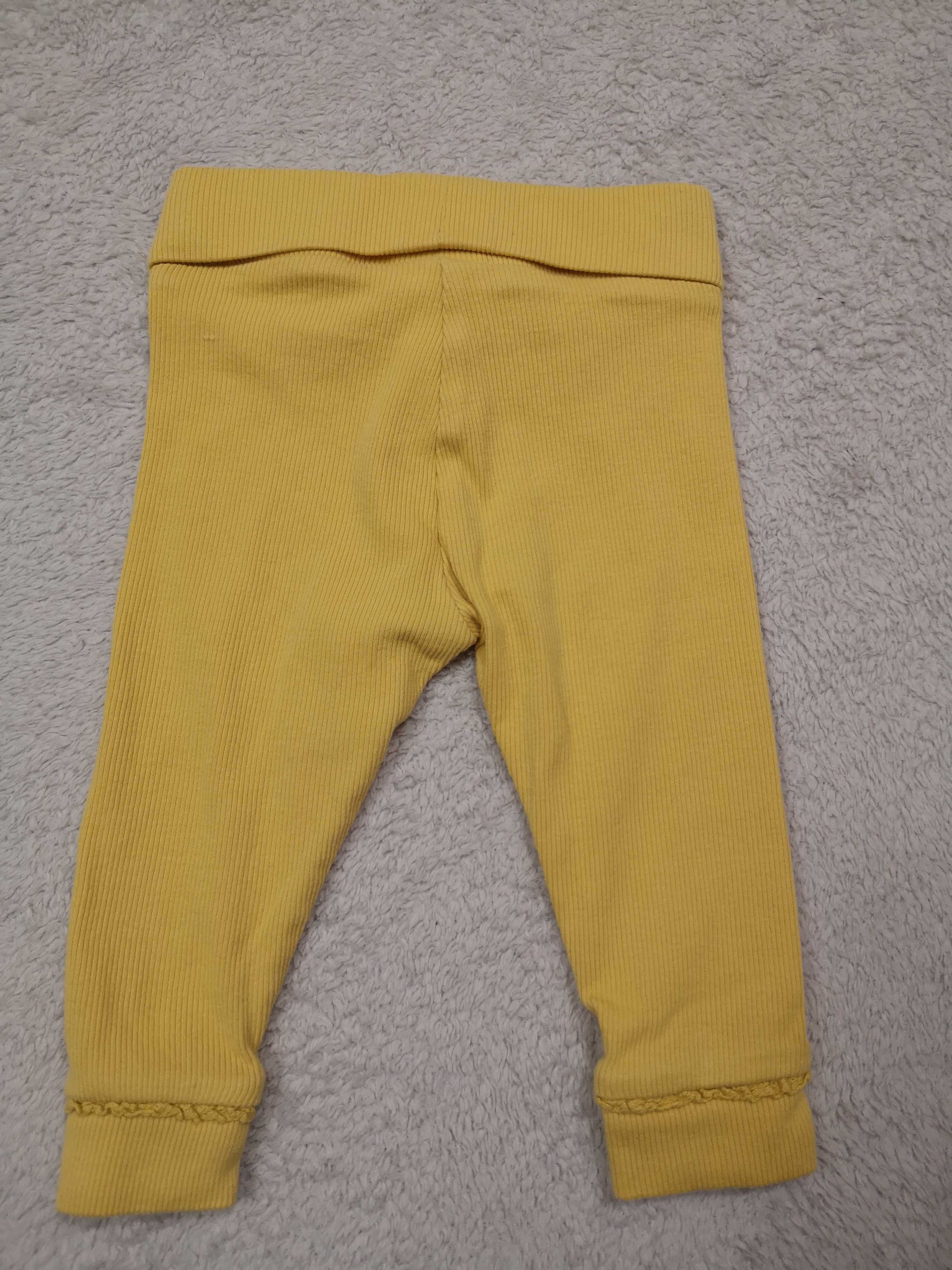 Żółte eleganckie prążkowane legginsy z falbanką Next 62 68 jak nowe