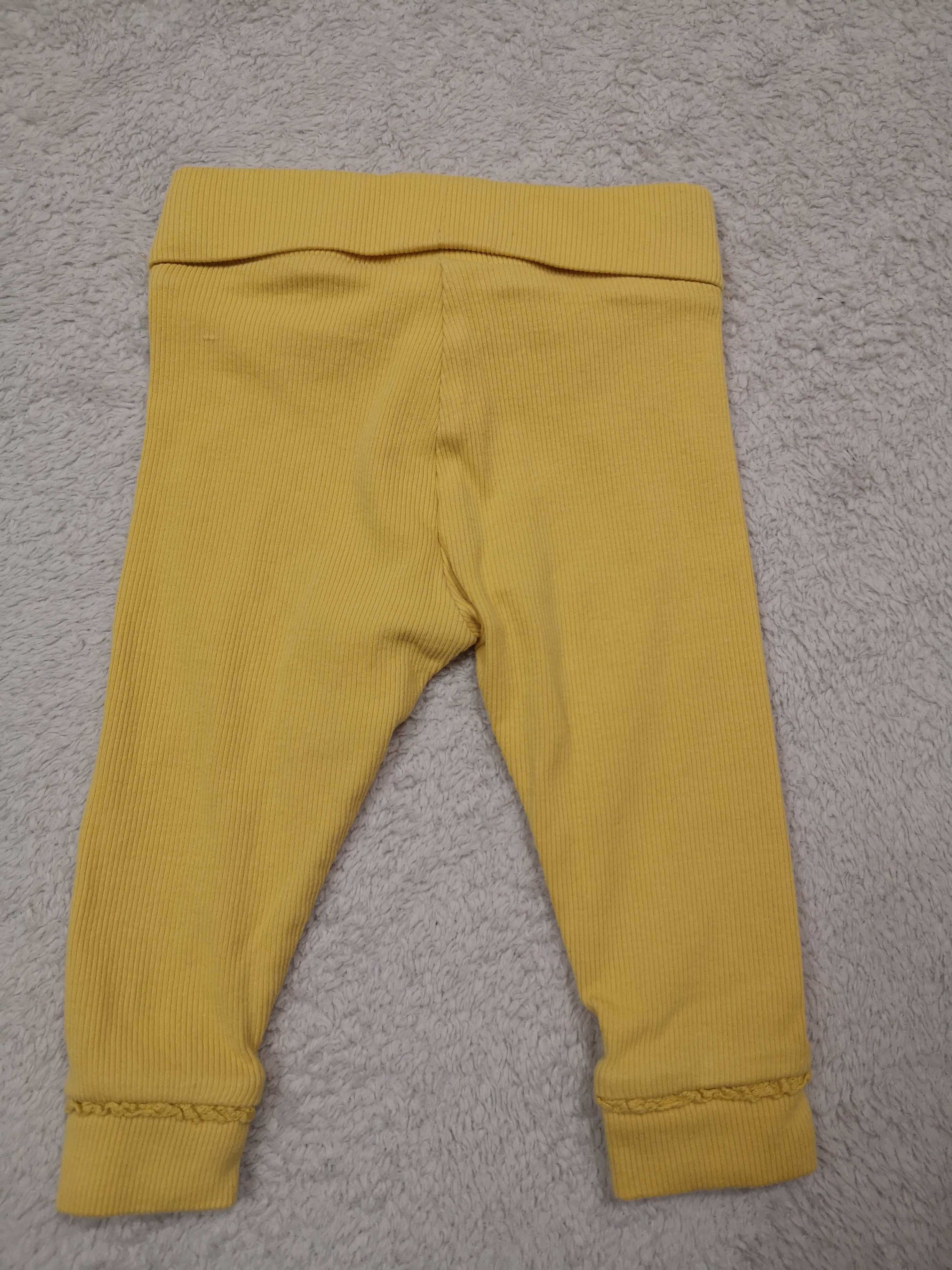Żółte eleganckie prążkowane legginsy z falbanką Next 62 68 jak nowe