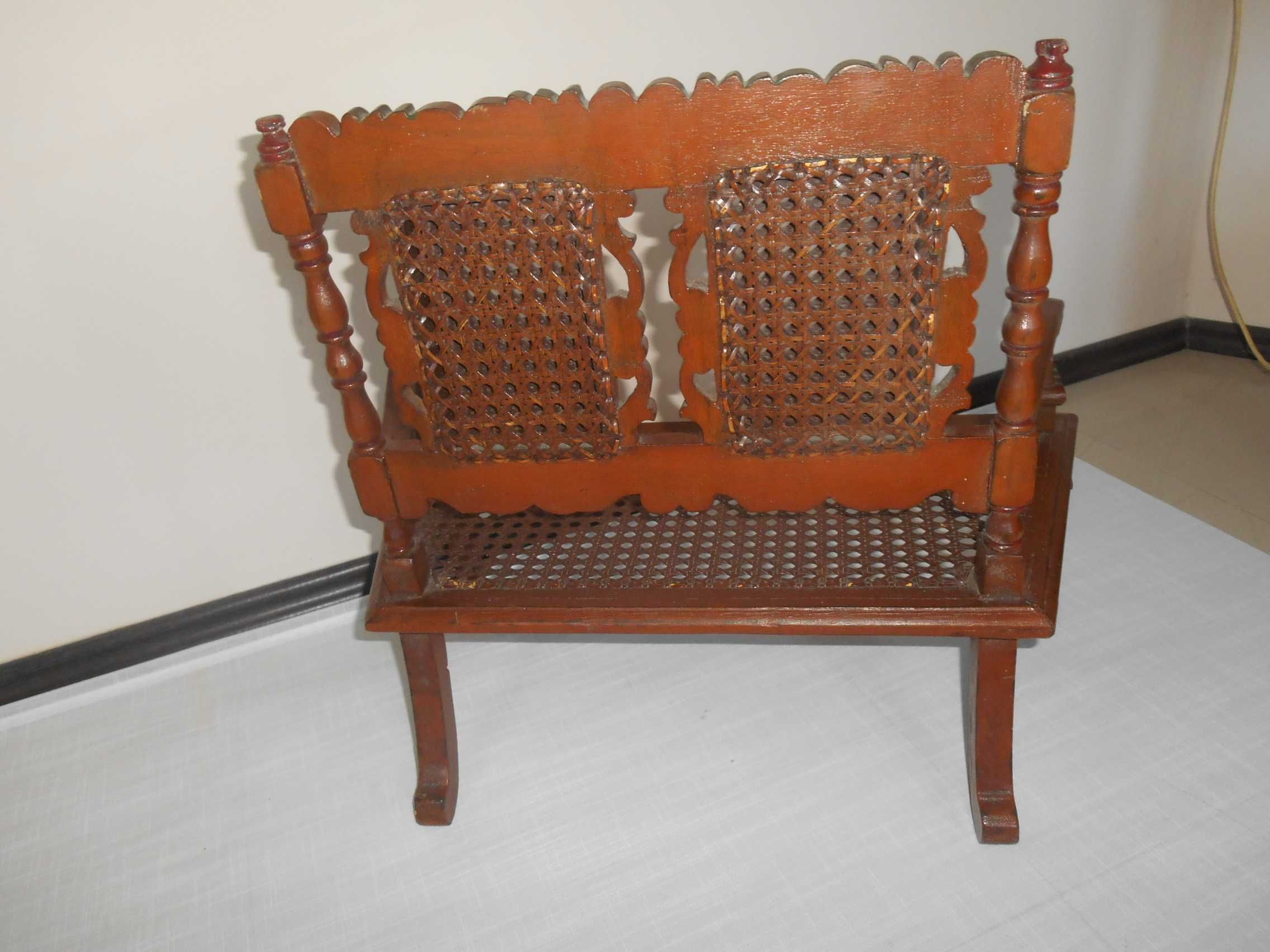 stara mała ławka drewniana, rzezbiona z rafią