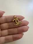Pendente dourado Chanel