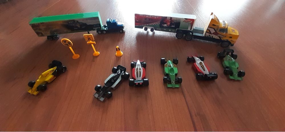 Conjunto de carros, com camião de transporte.