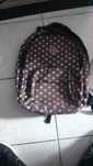 Mochila com 4 compartimentos e um caderno