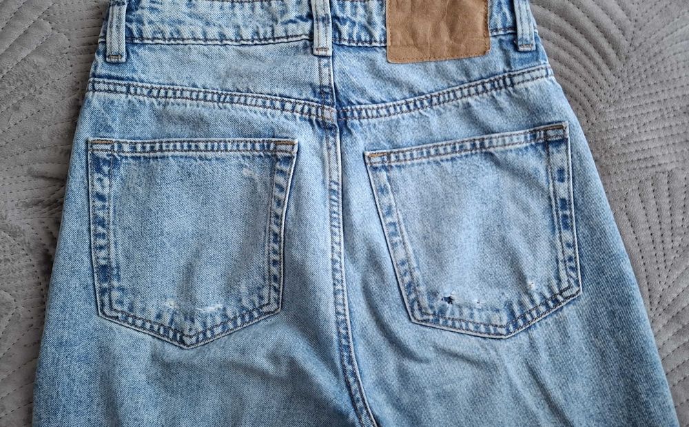 Spodnie jeansowe dzwony z dziurami, wąska talia, H&M rozm. 34