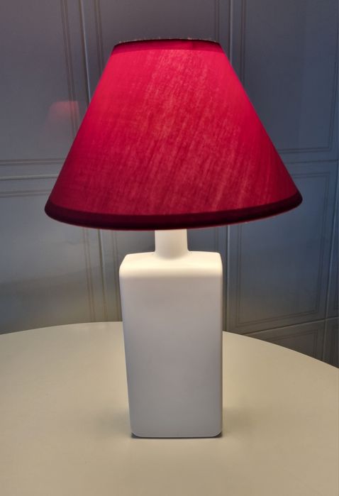 Candeeiro de mesa, feito com uma garrafa branca e abajour vermelho.