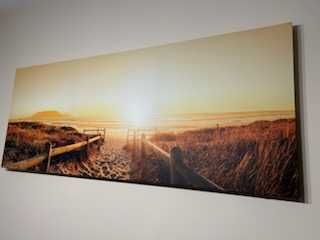 Obraz 150x60cm.Piękny wschód słońca nad morską plażą
