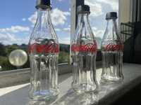 Tres garrafas da marca coca cola
