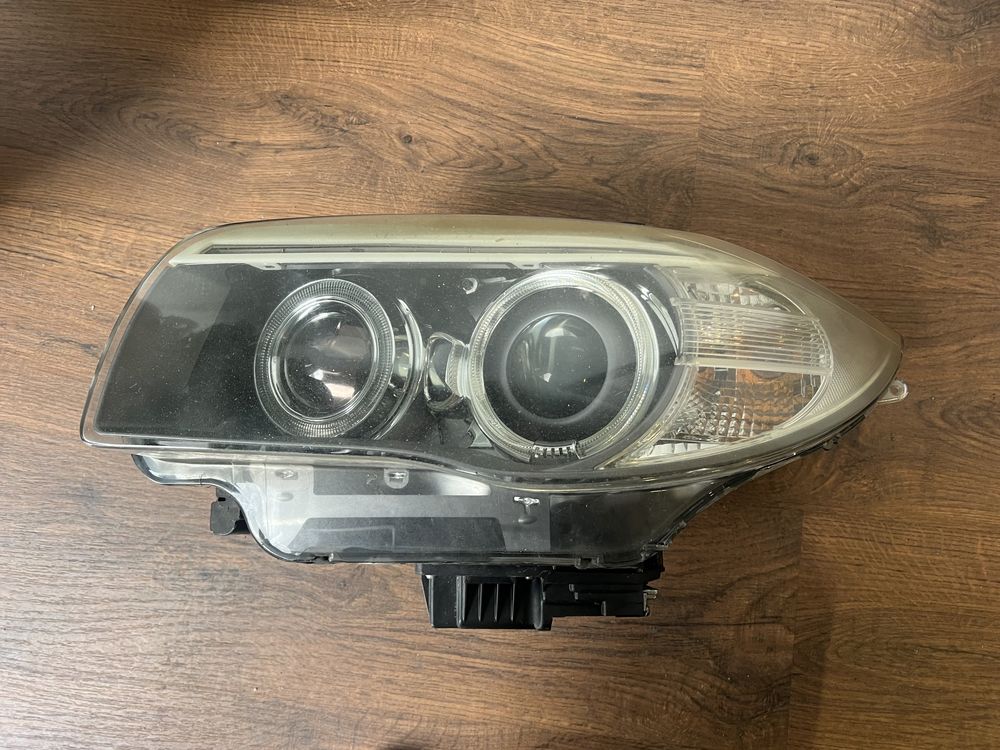 Farol bmw seri 1 lci esq