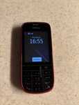 Nokia Asha 203, w zestawie ładowarka.
