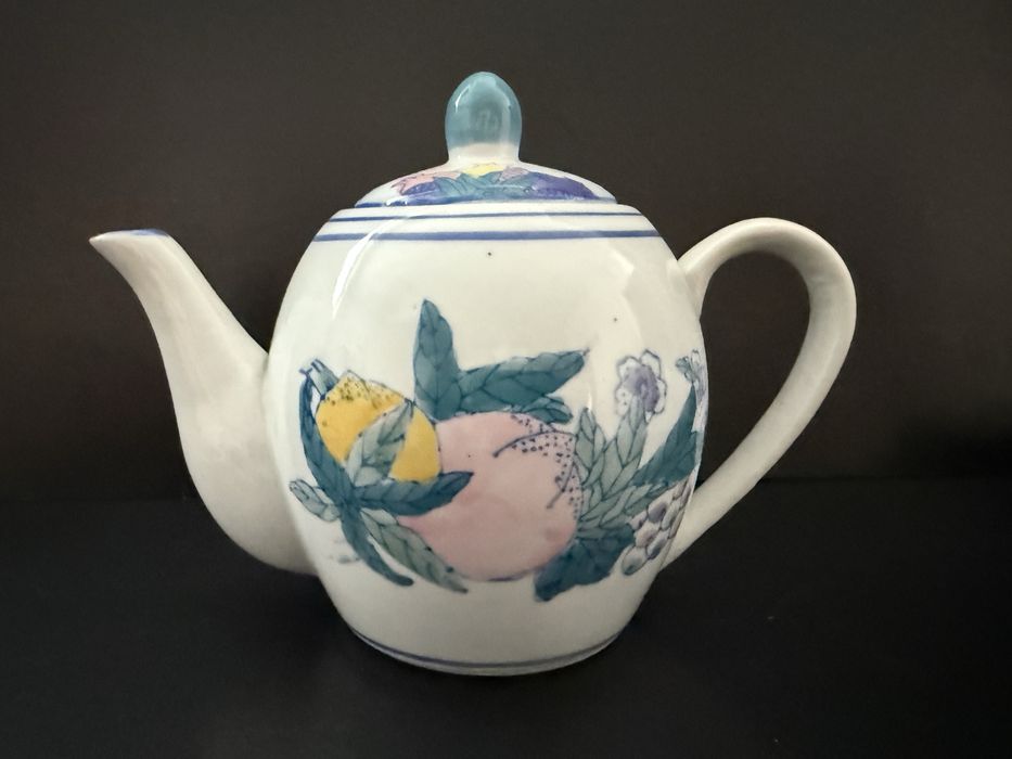 bule de chá de porcelana com uma decoração de frutas pintadas à mão.