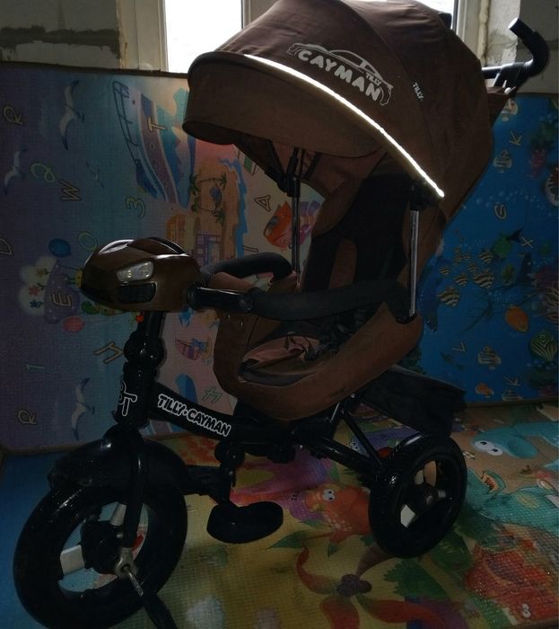 Продам детский музыкальный  велосипед-коляска Cayman.