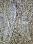 Wide-leg denim pants with a trippy swirl design.