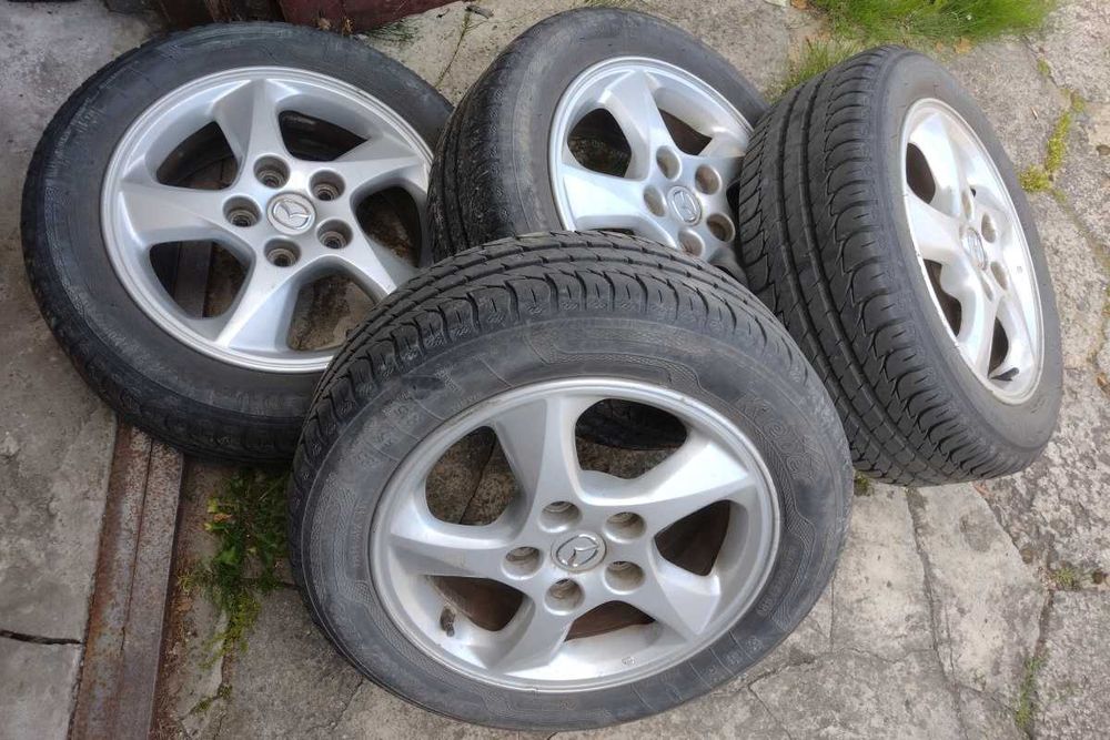 Mazda Felgi 15 cali Alu plus opony letnie 15x6JJ 5x114,3 ET50