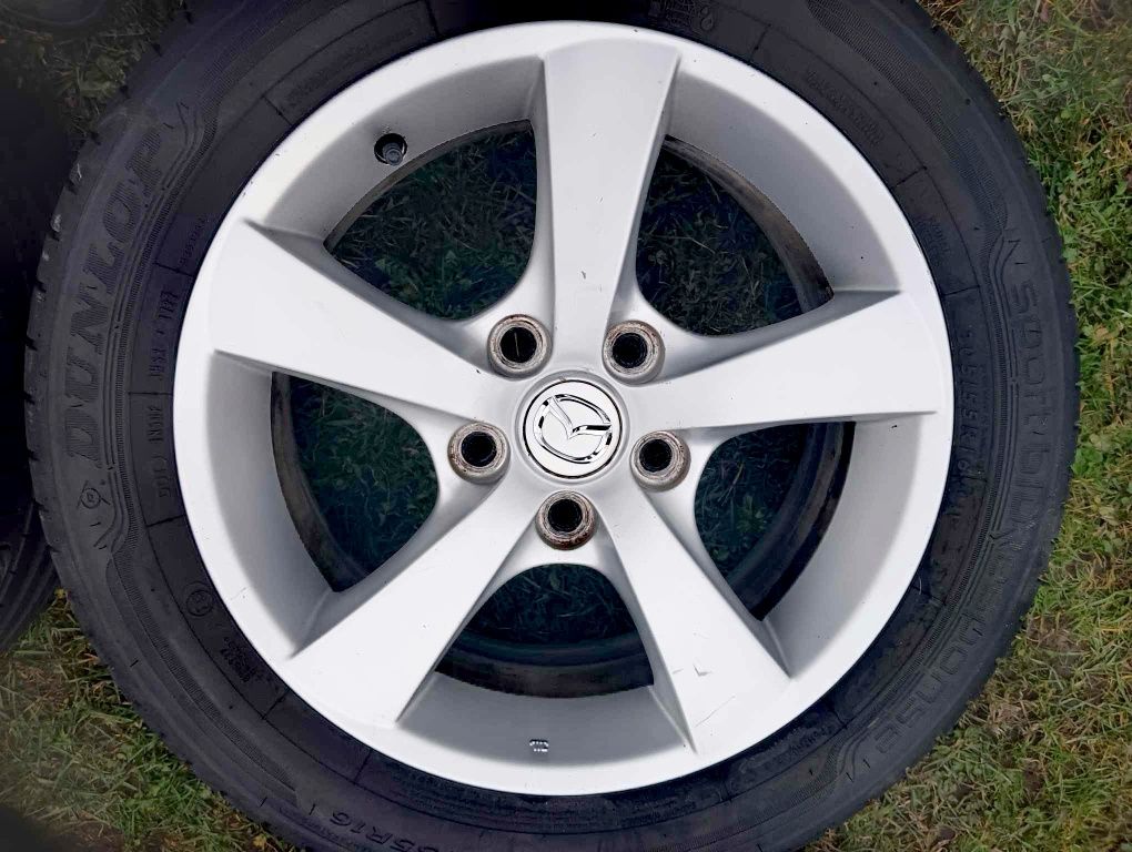 Oryginalne felgi aluminiowe mazda 16" z 2 letnimi oponami DUNLOP