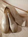 Botas pelo joelho em cru