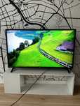 LG 43” 4K UHD Smart TV + FREE Stand table.