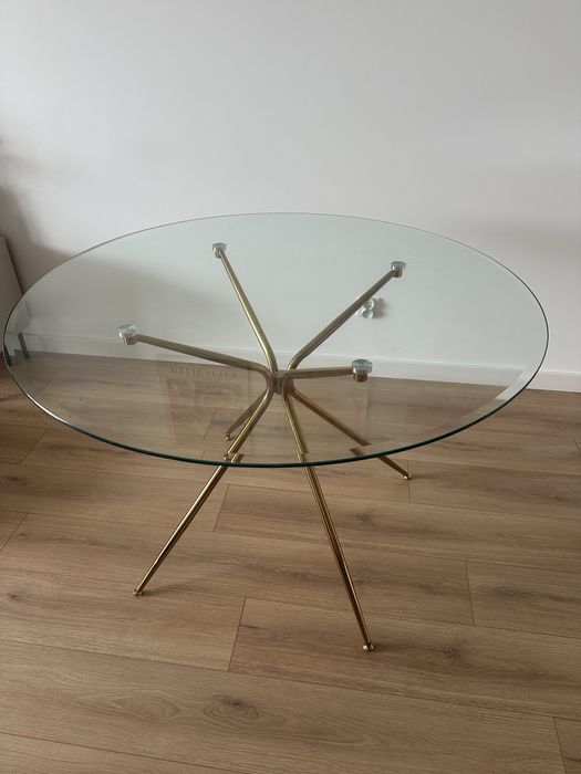 Szklany stół ze złotymi nogami