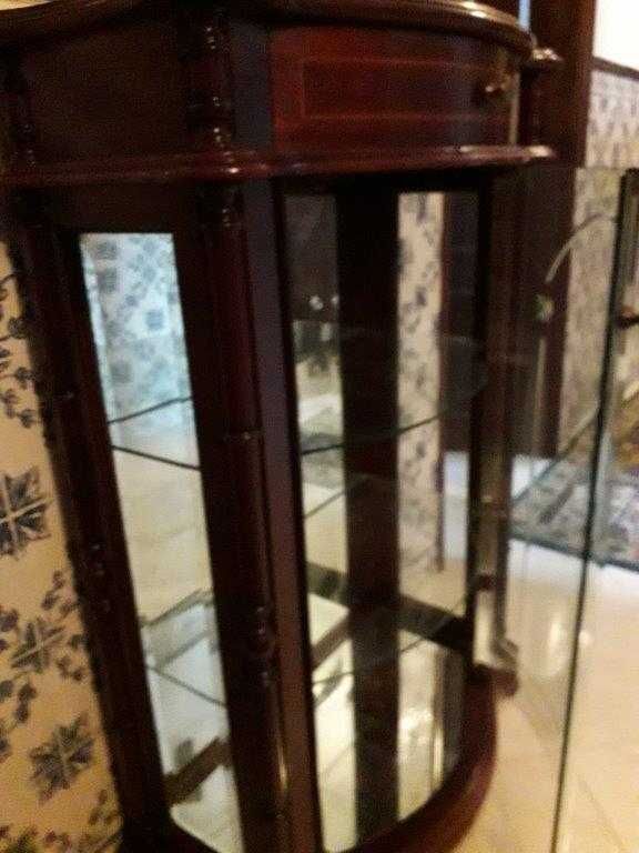 Móvel vitrine em mogno e portas com vidro e espelho no fundo.