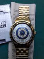 Swatch Irony, malha dourada, com estojo. Negociável.