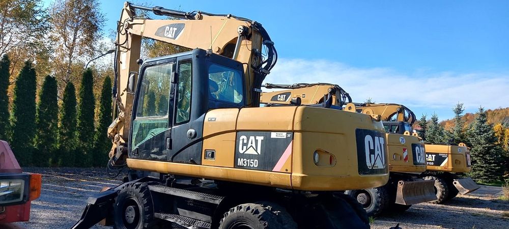 Caterpillar M315D rok 2010r podpory, chwytak obrotowy  Koparka kołowa CAT 315D rok 2010 chwytak obrotowy podpory pług