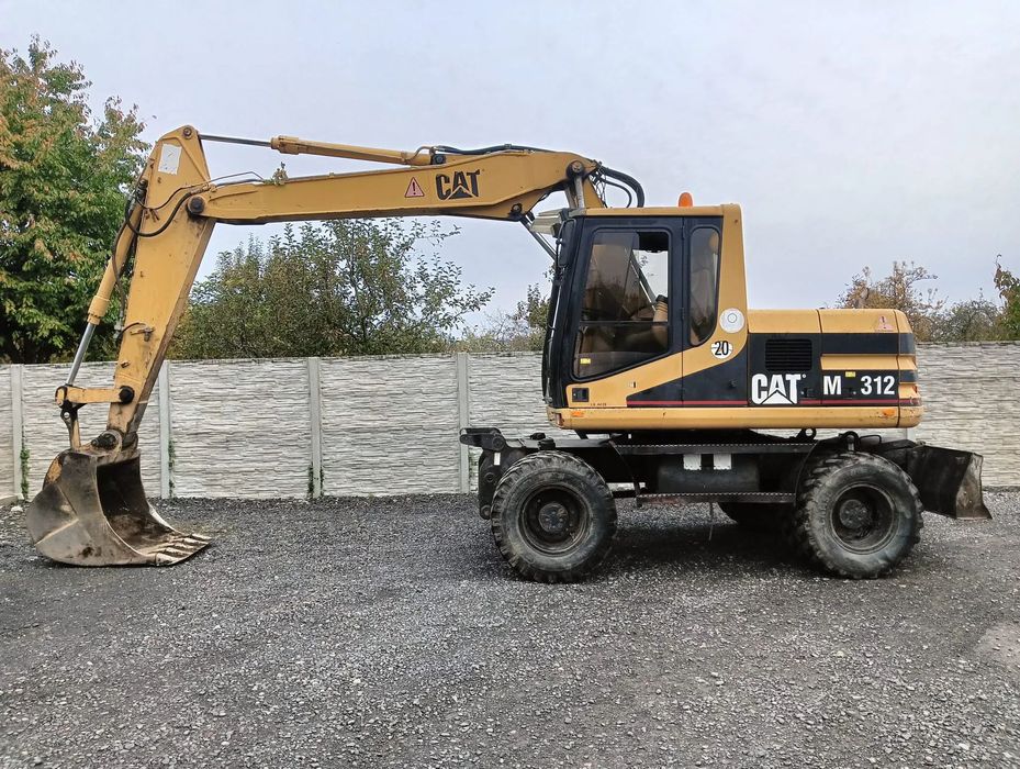 Caterpillar M312  Caterpillar M312 – koparka kołowa 1999 / Gotowa do pracy