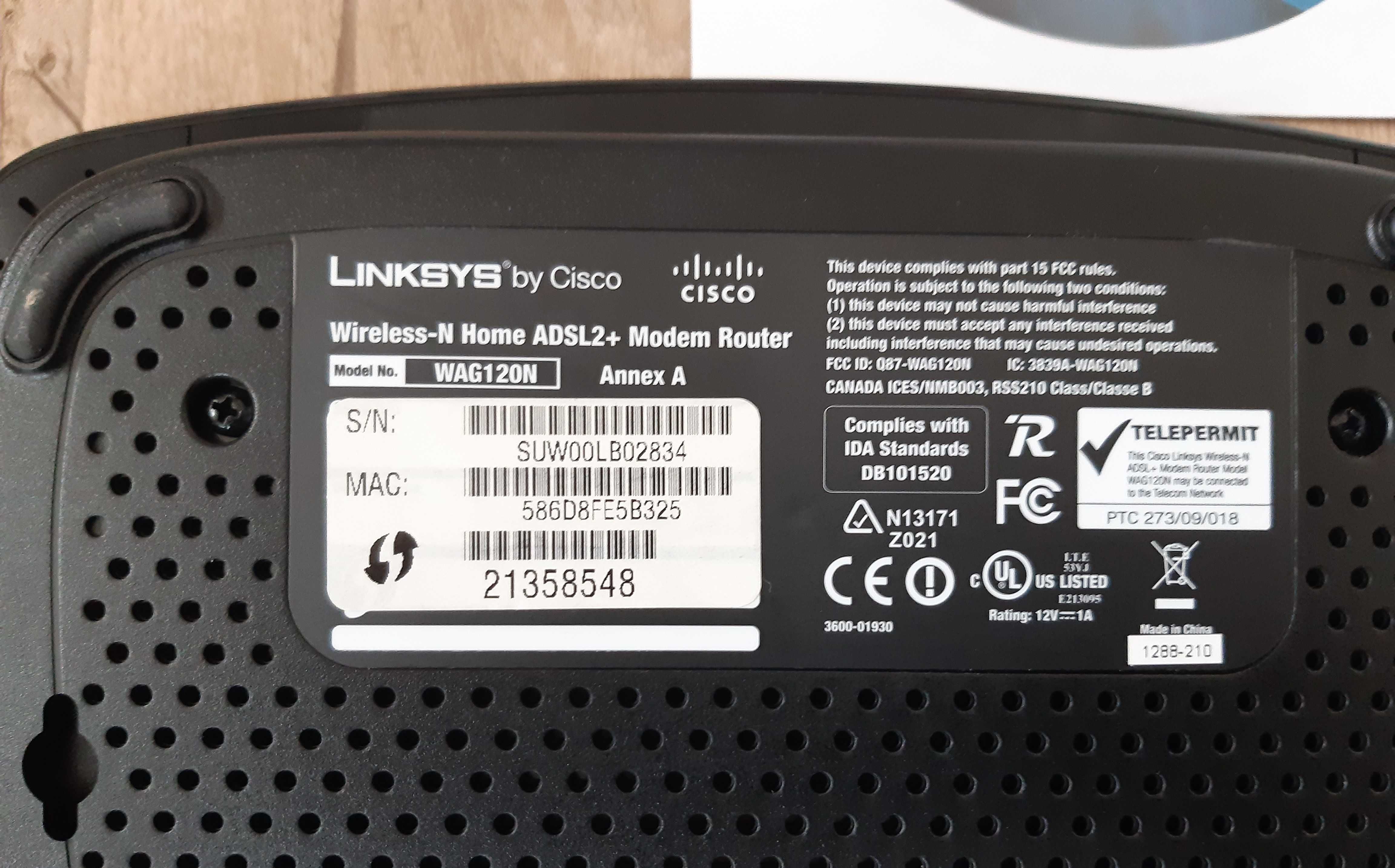 Router Cisco Linksys model WAG120N, oraz router Sagem Fast 2704 Orange