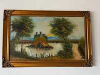 Quadro com paisagem e moldura dourada