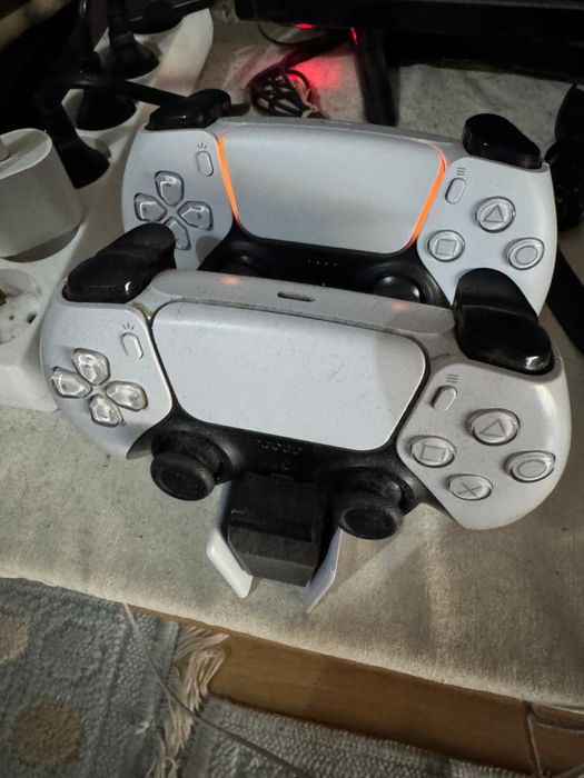 PS5 com 2 comandos e plataforma de carregamento