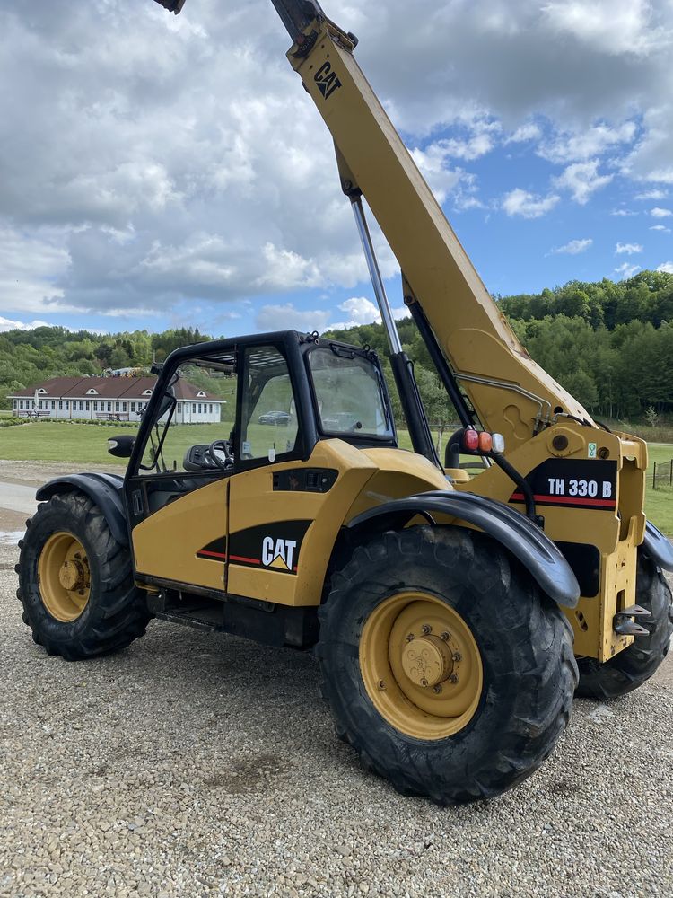 Cat TH 330 spr z Francji  7m 2004r